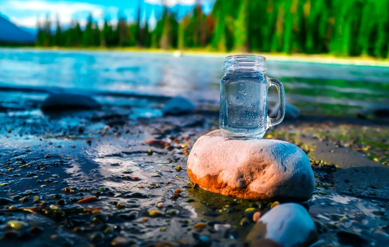 clear glass jar on brown rock